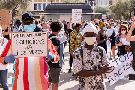 Palma de Mallorca, Spain - June 07 2020: Mens surrounded by crowd holding banners in a peaceful protest against racism and recent US police brutalityのeditorial素材