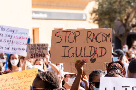 Palma de Mallorca, Spain - June 07 2020: Man surrounded by crowd holding a placard in a peaceful protest against racism and recent US police brutalityのeditorial素材