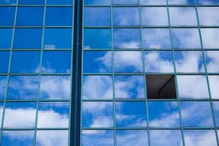 building with open window and facade reflecting clouds and blue sky in Nice cote d'azur in France