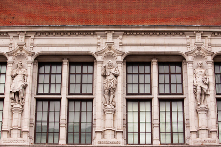 The facade of Victoria and Albert museum with three stautesのeditorial素材