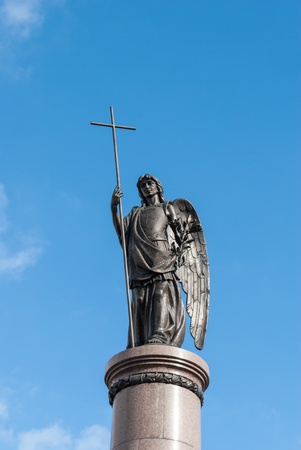 Statue of an angel with a cross の写真素材