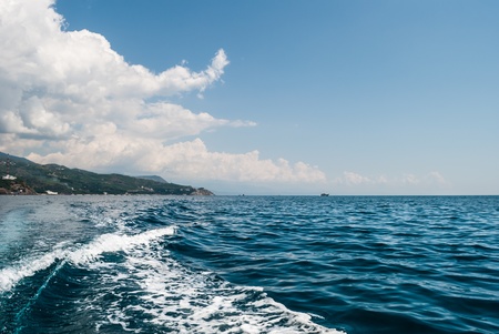 Small waves on a quiet black sea. The rocky coast of the Crimea.の写真素材
