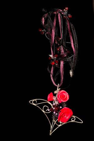 Unique handmade wire-work pendant with pink polimer clay rosesの写真素材