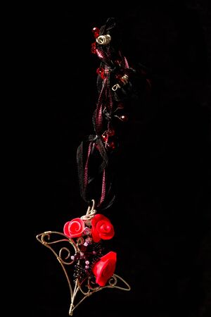 Unique handmade wire-work pendant with pink polimer clay rosesの写真素材