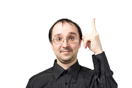 Solid men points upward and draws attention isolated on whiteの写真素材