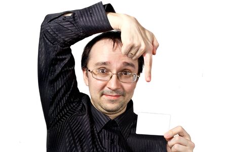 Solid men points to the businesscard and draws attention isolated on whiteの写真素材