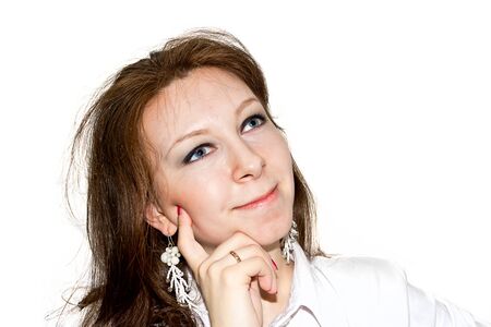 Wishing beautiful women looking upwards isolated on whiteの写真素材