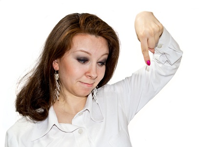 Young women points downward and draws attention isolated on whiteの写真素材