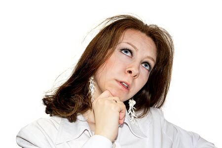 Wishing beautiful women looking upwards isolated on whiteの写真素材