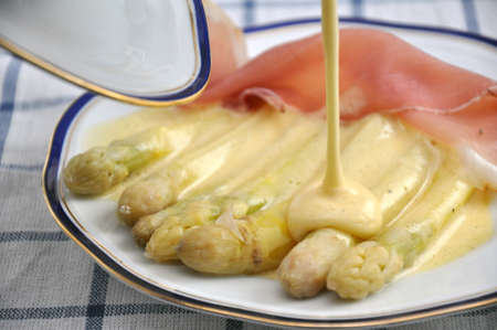 white asparagus, sauce hollandaise and hamの写真素材