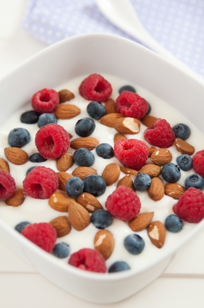 Yoghurt with fresh berries and almondsの写真素材