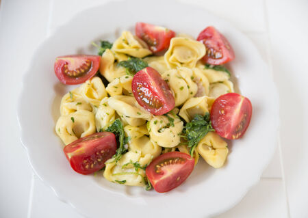 Tortellini with tomatoesの写真素材