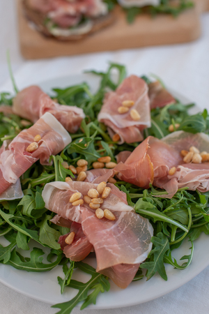 Healthy salad with prosciutto, tomato and green leavesの写真素材