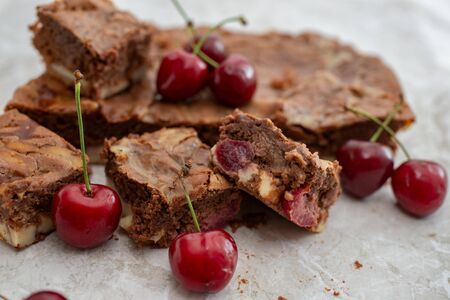 Chocolate brownie pieces decorated with cherry