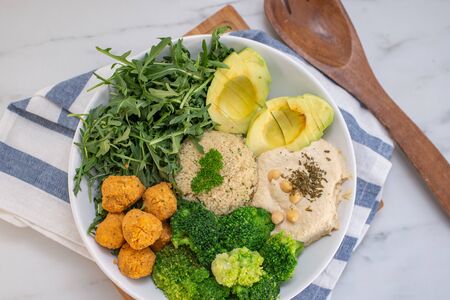 Buddha bowl. Vegan rice and vegetables salad. Macrobiotic set with rice, hummus, avocado, broccoli