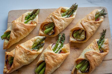 Asparagus baked in puff pastry with ham and cheeseの写真素材