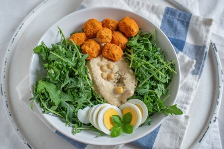 Healthy superbowl or Buddha bowl with salad, baked sweet potatoes, chickpeas,