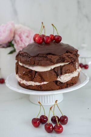 Black forest chocolate cake with cherry pie filling with dark chocolate glaze