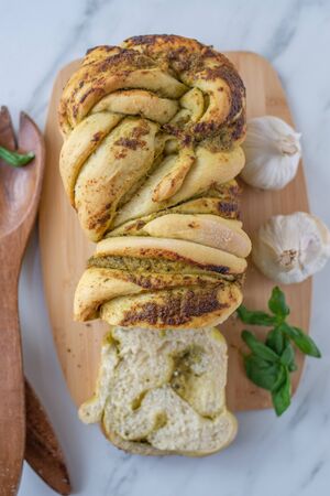 Home made braided basil pesto bread on a tableの写真素材