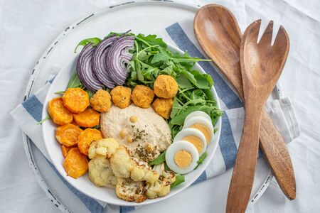 Healthy superbowl or Buddha bowl with salad, baked sweet potatoesの写真素材