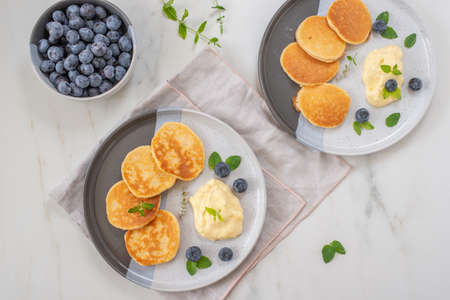 pancakes with blueberries and vanilla sauce for breakfastの写真素材
