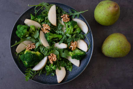 healthy arugula salad with pears and walnutsの写真素材