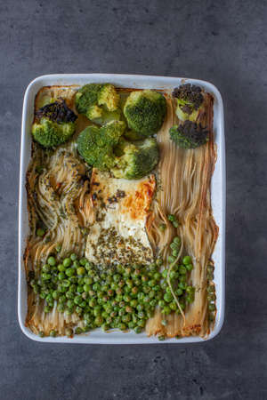 baked green pasta with vegetables and feta cheeseの写真素材