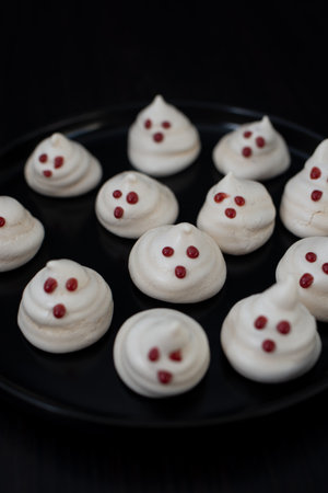 Funny meringue ghosts with funny faces, Halloween dessertの写真素材