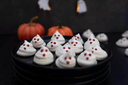 Funny meringue ghosts with funny faces, Halloween dessertの写真素材
