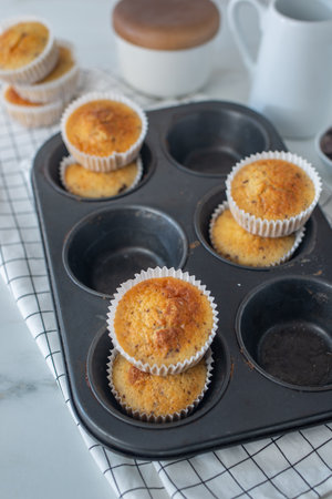 <p>sweet home made vanilla muffin with chocolate on a table</p>