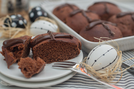 chocolate orange hot cross buns..traditional easter pastries on a tableの写真素材