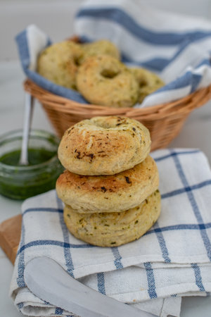 home made whole grain bagels with wild garic on a tableの写真素材