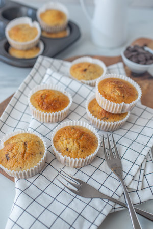 sweet home made vanilla chocolate muffins on a tableの写真素材