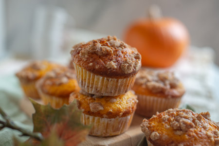 Fresh homemade pumpkin walnut oatmeal muffins on a tableの写真素材