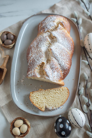 Sweet home made braided yeast bun for Easter on a table