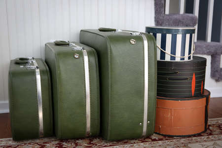 Vintage luggage and hatboxes waiting in a foyer.の写真素材