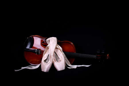 Ballet en pointe shoes with a violin on a black background.の写真素材