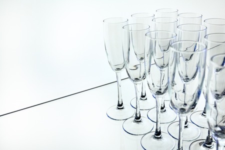Rows of Empty Glasses on the table white backgroundの写真素材