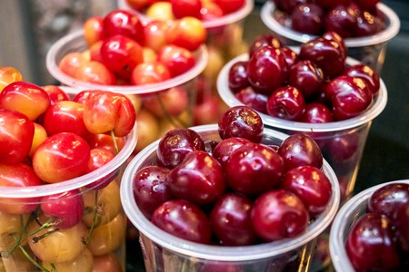 Cherry red and yellow in plastic glasses lightの写真素材