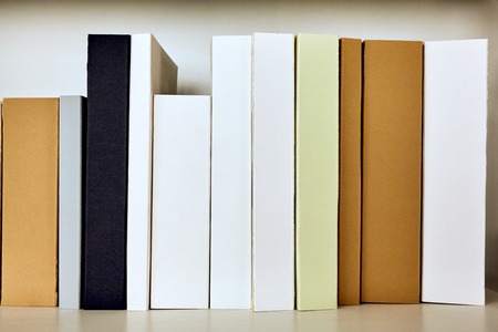 The roots of books are empty on the shelf white backgroundの写真素材