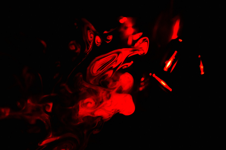 Smoke abstraction red color black backgroundの写真素材