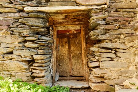 old wooden door in a stone wallの写真素材
