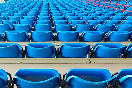 empty bleachers and chairs in blue indoorの写真素材