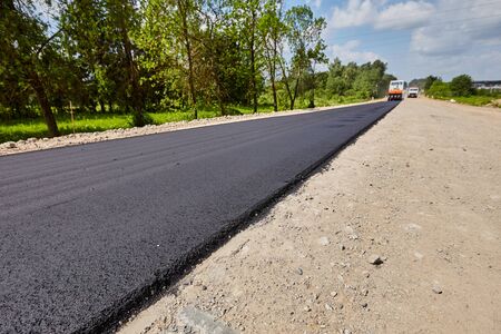 Construction of a road with rubble and sand on a sunny dayの写真素材