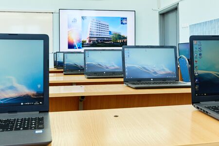 Minsk, Belarus, April, 6, 2020. A row of laptops stands on the tables in the office daylightの写真素材