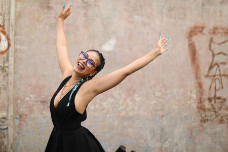 Latin Urban Playful Girl Smiling Raising Hands