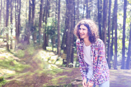Young latin american man in the forest looking left with a laughing expression at Costa Ricaの写真素材