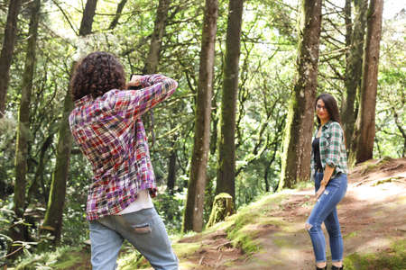 Anonymous profesional Photographer taking photographs of model posing in the forest at Costa Rica