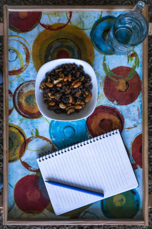 plate of nuts and notebook, indoorsのeditorial素材