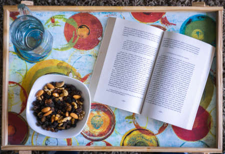plate of nuts and a book, indoorsのeditorial素材